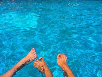 Low section of feet in swimming pool