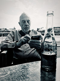 Portrait of man drinking glasses on table