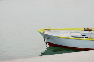 Boat moored in lake against sky