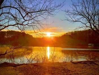 Scenic view of lake against sky during sunset