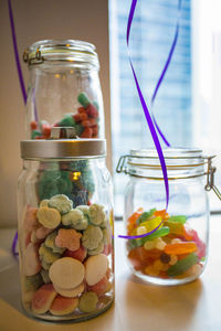 Close-up of candies in glass jar on table