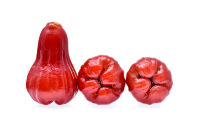 Red fruits over white background