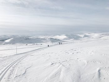 Scenic view of snow covered mountains against sky