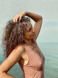 Rear view of woman standing at beach