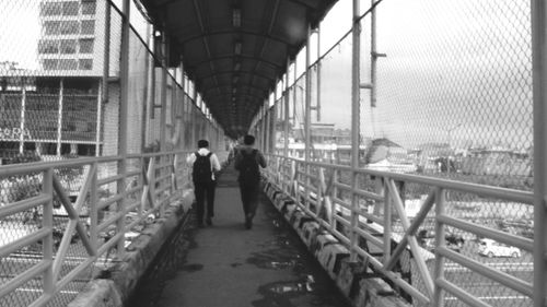 People on footbridge in city
