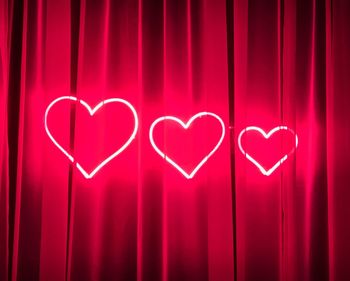 Illuminated heart shapes on curtain