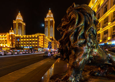 Statue of illuminated buildings at night