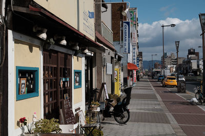 View of vehicles on road along buildings