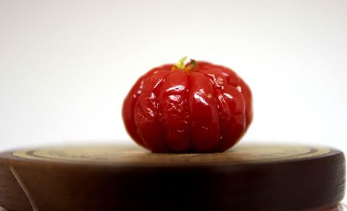 Close-up of strawberry on table against white background