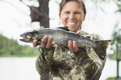 Woman holding caught fish