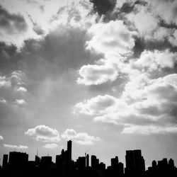 Low angle view of buildings against cloudy sky