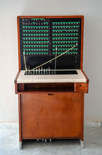 Close-up of antique telephone switchboard against wall