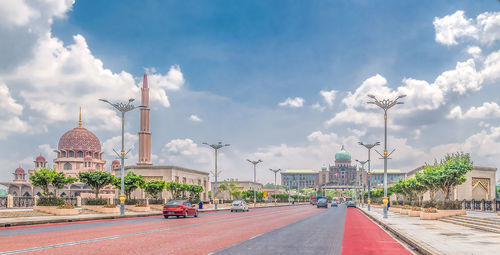 Road amidst buildings against sky in city