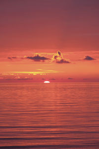 Scenic view of sea against romantic sky at sunset