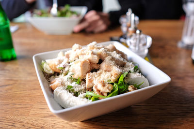 Close-up of cheese chicken salad in bowl on table