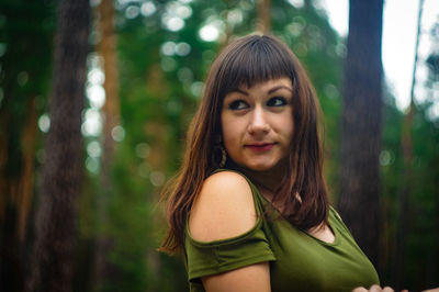 Portrait of young woman in forest
