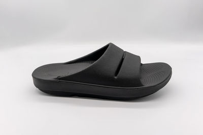 Close-up of shoes on table against white background