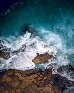 Waves splashing on rocks at shore