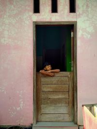 Boy sleeping in front of door