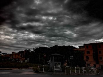 Buildings against cloudy sky