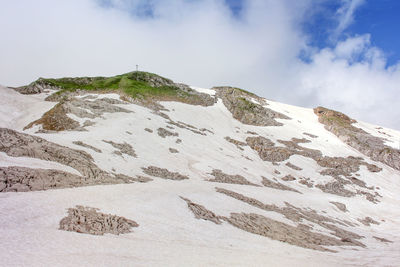 Scenic view of mountains against cloudy sky