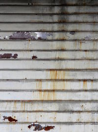 Full frame shot of rusty metal grate against wall