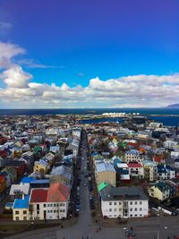 High angle view of cityscape against blue sky