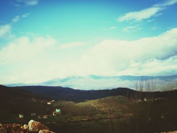 Scenic view of mountains against cloudy sky