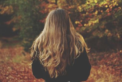 Rear view of woman standing against bright sun