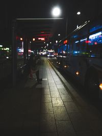 Illuminated railroad station platform at night