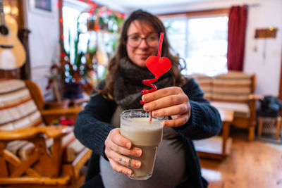 Portrait of woman holding milkshake