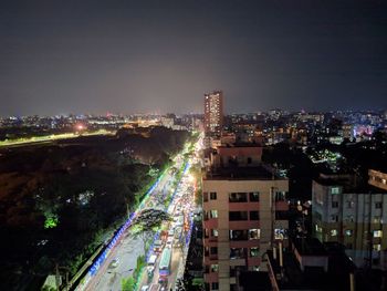 High angle view of illuminated buildings in city at night