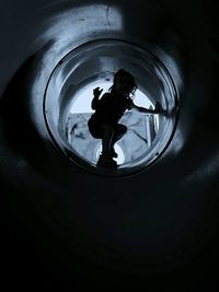 High angle view of silhouette man standing in dark