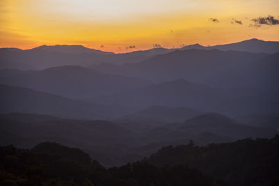 Scenic view of silhouette mountains against sky during sunset