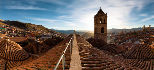 Roof tile of buildings in town against sky