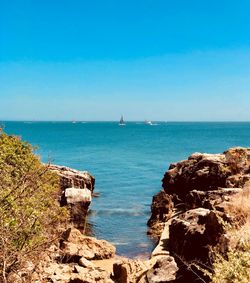 Scenic view of sea against clear blue sky