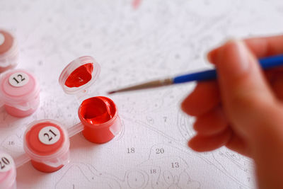 Close-up of hand holding red table