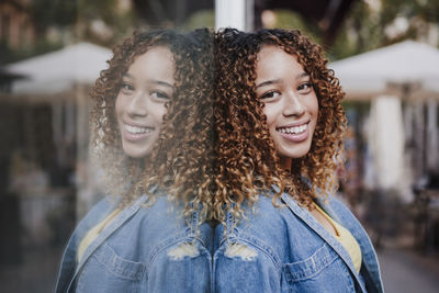 Portrait of a smiling young woman in city
