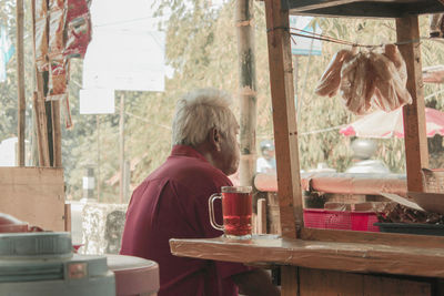 Woman sitting on table at restaurant