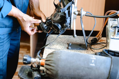 Midsection of man working in factory