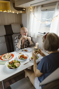 Retired senior couple eating lunch together in motor home