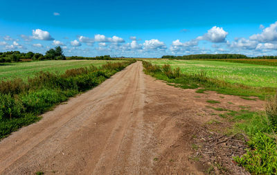 Dirt road along countryside landscape