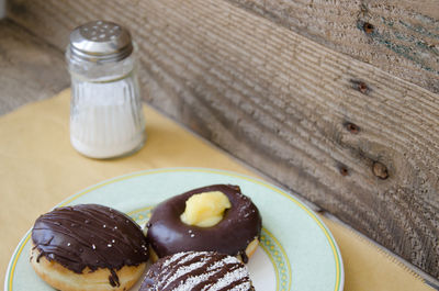 High angle view of donuts in plate on restaurant table