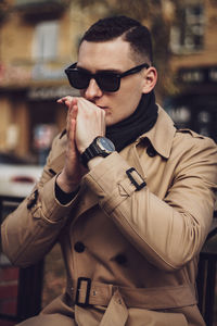 Young man wearing sunglasses while standing outdoors