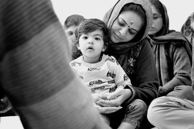 Portrait of mother and girl sitting outdoors
