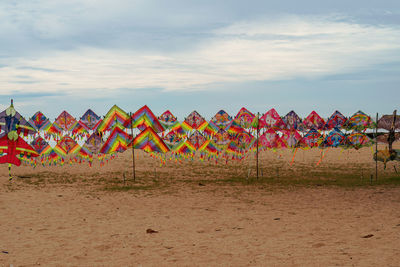 Colourful kites on display for sale at the beach.