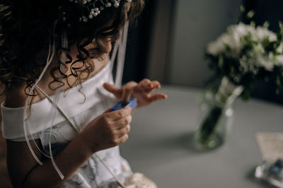 Midsection of girl holding toy at home