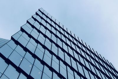 Low angle view of glass building against clear sky