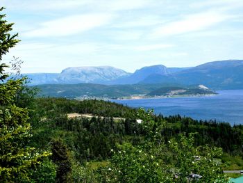 Scenic view of sea and mountains against sky