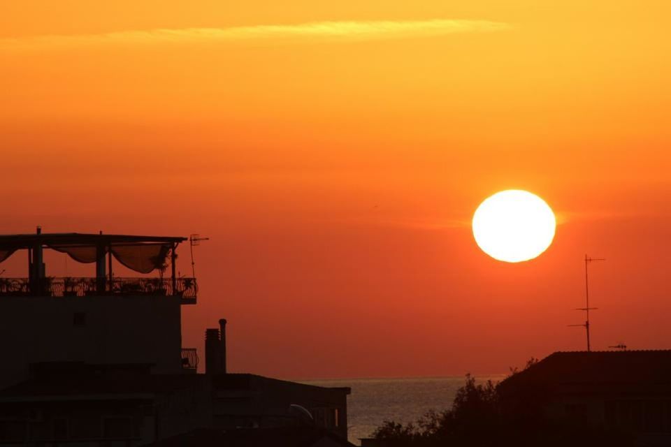 sunset, orange color, architecture, built structure, building exterior, silhouette, sky, scenics, sun, beauty in nature, idyllic, nature, house, tranquility, tranquil scene, romantic sky, outdoors, copy space, sea, residential structure